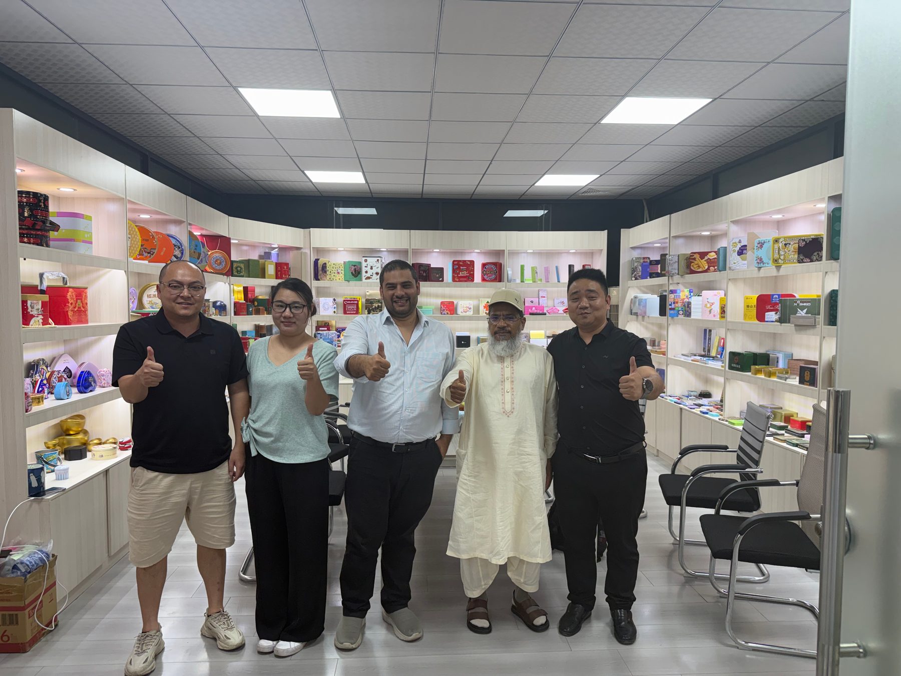 Overseas buyers reviewing tin packaging in Junmei sample room