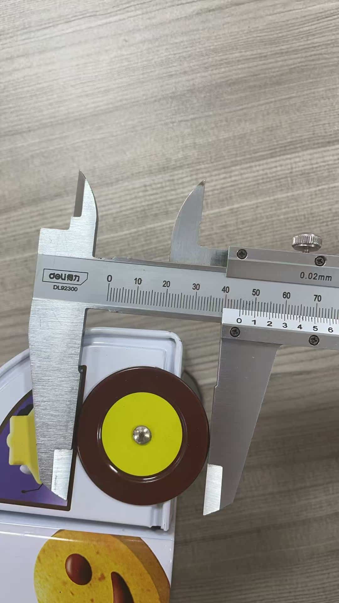 Caliper checking a round tin component