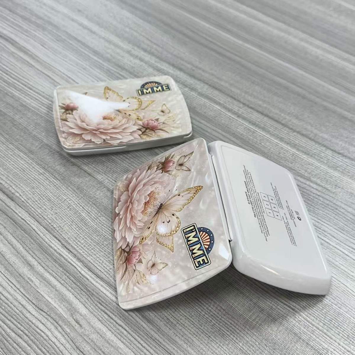 Finished custom hinged rectangular tins showing printed lid and inside structure