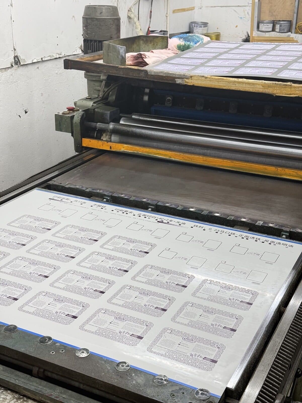 Real printed tinplate sheets reviewed for a custom tin project